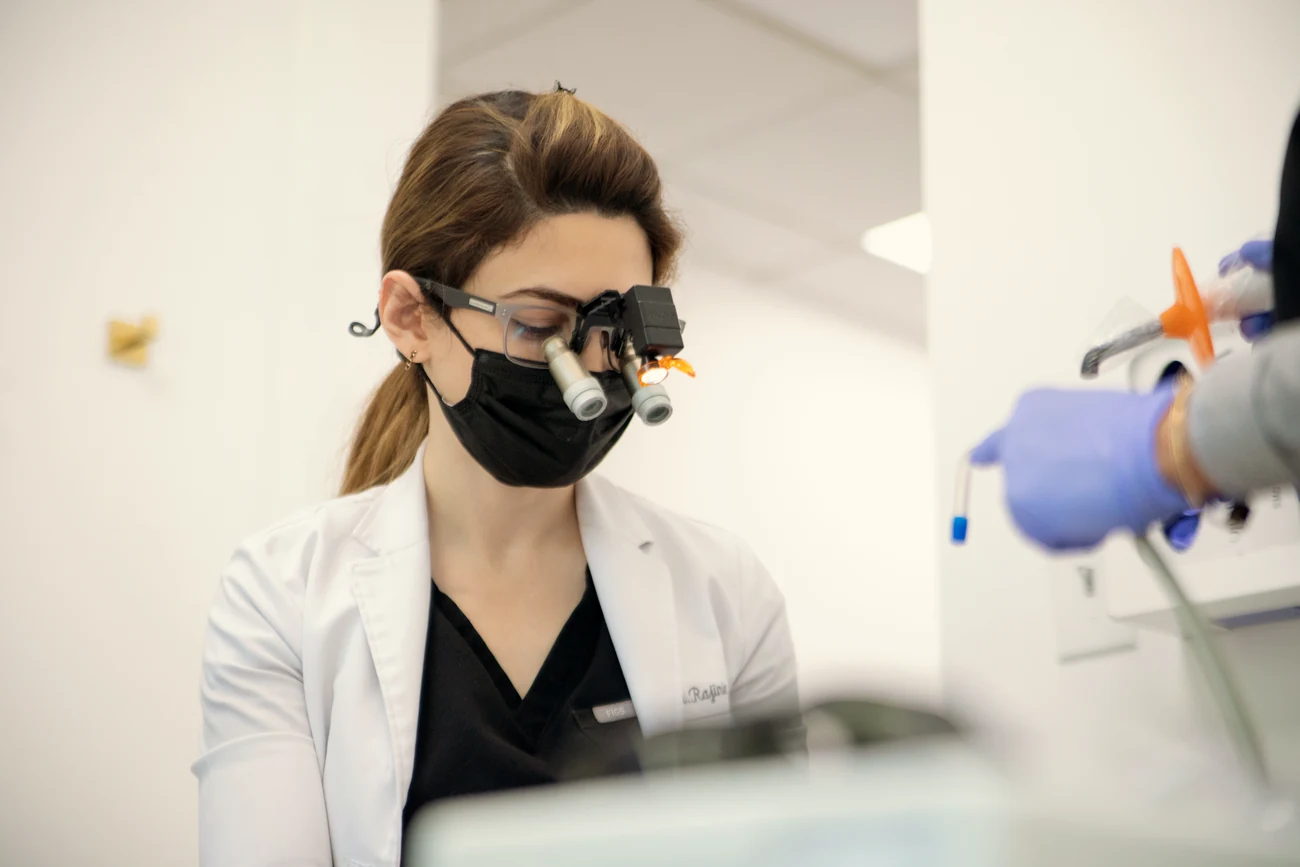 Dr. Mersedeh Rajinia performing precision implant work under magnification